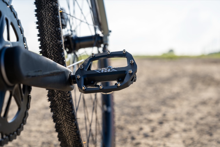 Origin8 Dual Sport pedal mounted on a gravel bike in an open field