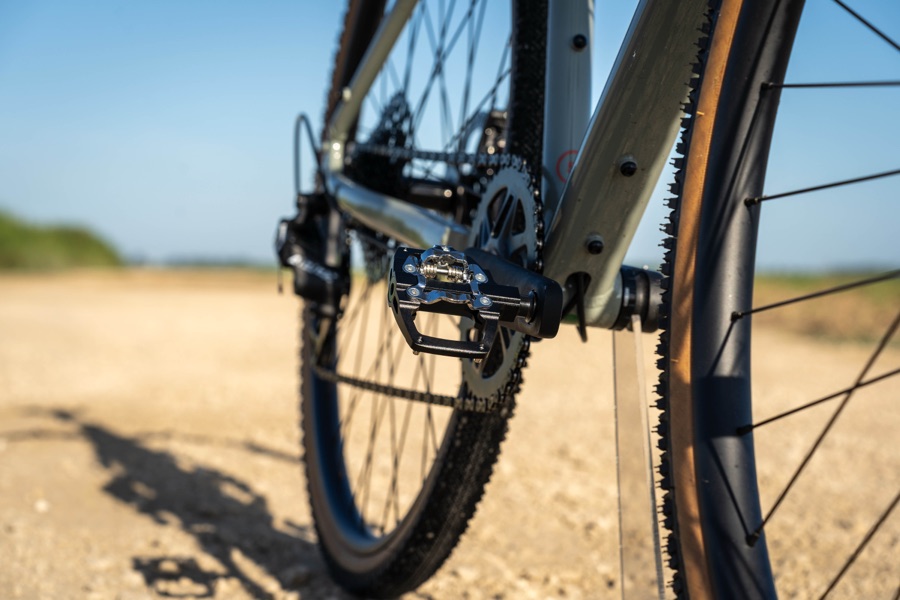 Origin8 Dual Sport pedal mounted on a gravel bike on a dirt road